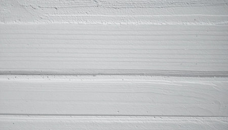 close-up of a white-painted wooden surface showing the texture of the grain.の素材