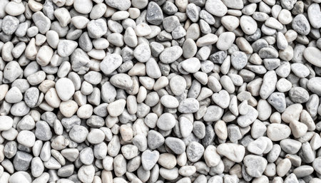 dense collection of small, smooth white and light grey pebbles filling the frame.の素材