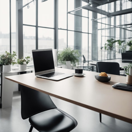 Laptop and coffee cup on the table in modern office with panoramic windowsの素材