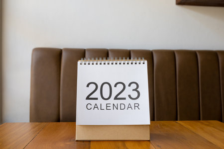 Close up calendar 2023 on table with coffee cup.の写真素材