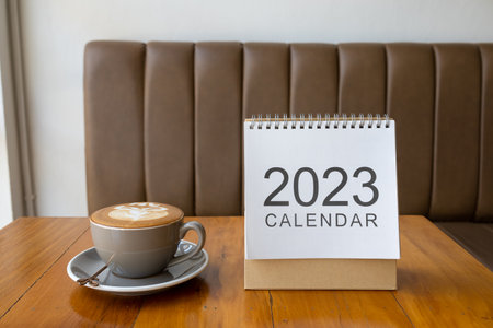 Close up calendar 2023 on table with coffee cup.の写真素材