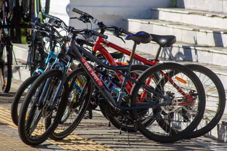 Various bicycles on a rack available for rentの写真素材