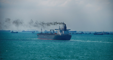 Black Smoke from Ship Sailing on the High Seaの写真素材
