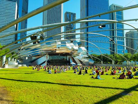 Chicago, Illinois, USA. 07 07 2018. Big group of people practice yoga in Pritzker Pavilion, park Millenium.のeditorial素材