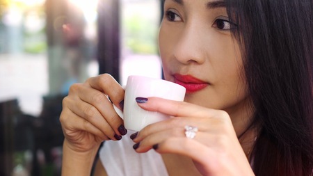 Asian woman drinking coffee in the morning.の写真素材