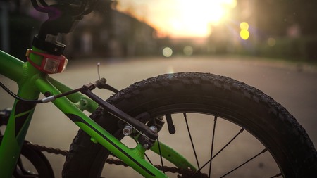 Closeup of bicycle wheel with sunset background.の写真素材