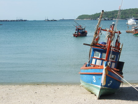 Thai fishing wooden boat at the beach in Sri Chang island, Thailand.の写真素材
