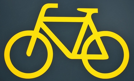 Yellow bike logo on black background.の写真素材