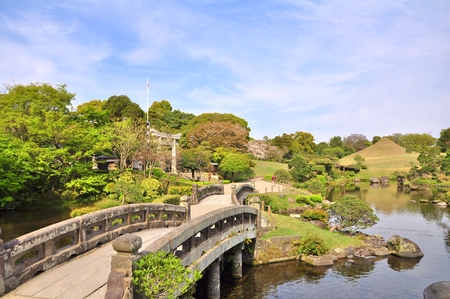Stone bridge in Suizen-ji Joju-en garden at Kumamoto Prefecture, Kyushu, Japan. Suizenji Jojuen Park is a traditional Japanese garden landscaped around a natural spring pond.のeditorial素材