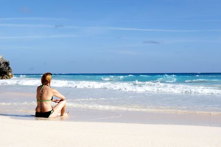 a woman watching the oceanの写真素材