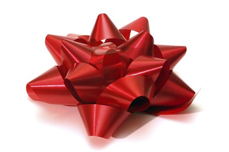 A single isolated red christmas bow on a field of white