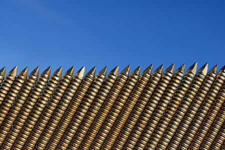 A simple row of sharp nails and blue skyの写真素材