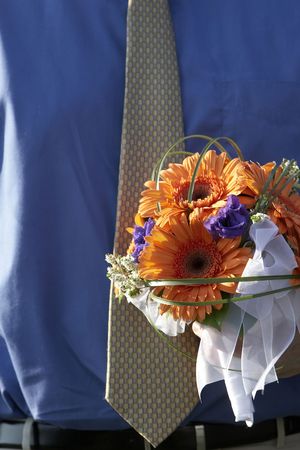 A man waring a tie and shirt is holding the brides bouquetの写真素材