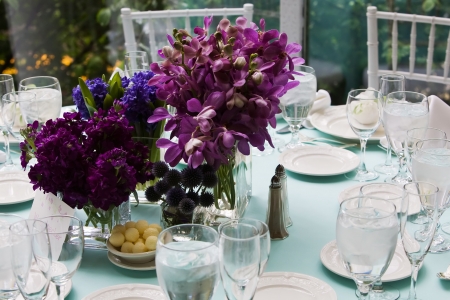 Beautiful purple bouquet of flowers on a table set for dinner