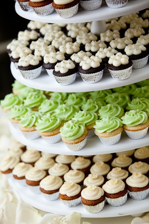 mini cupcakes on a multi level tier in different colorsの写真素材
