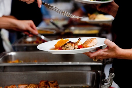 a person in line with their food during a banquet or other catered eventの写真素材