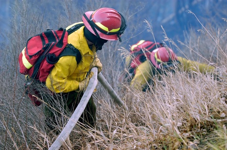 a team of firefighters battle a grass fire in coloradoの写真素材