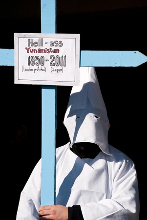 VEVCANI, MACEDONIA - JANUARY 13, 2012: A masked participant with a cross at Vevcani Carnival,...