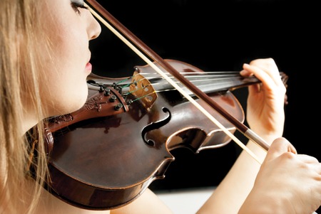 A young woman playing a violinの写真素材