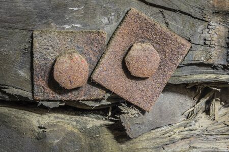 Rusty screws in a wooden construction