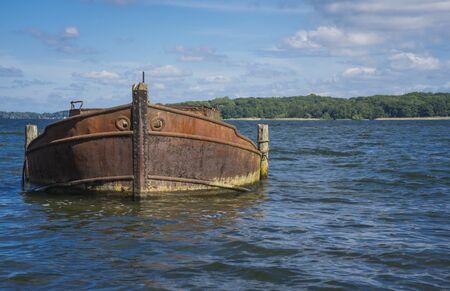Old boat on the shore of a lakeの写真素材