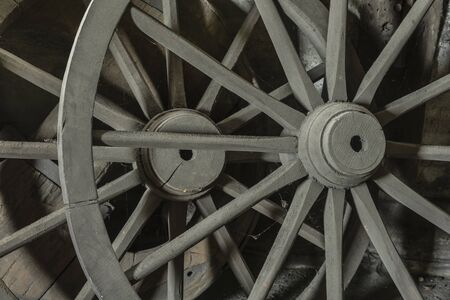 Old wagon wheel in a barnの写真素材