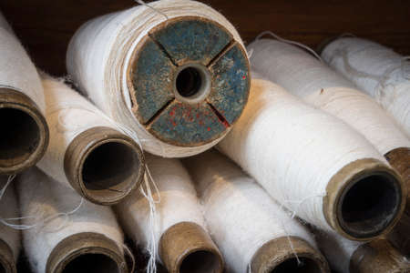 spools with thread for using in a loomの写真素材