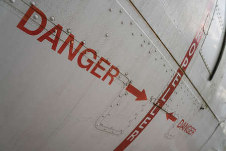 hazard sign on an old airplane hullの写真素材