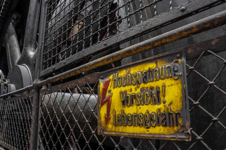 German high tension warning sign on a historic generator
