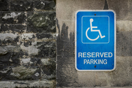 Reserved parking sign on a historic wall in London.の写真素材