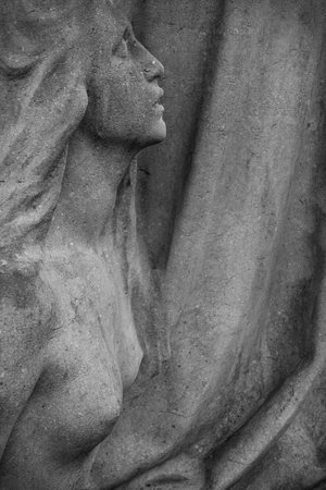 statue of a woman on an old tombstoneの写真素材