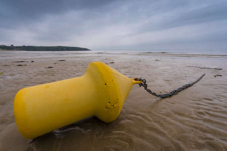 yellow buoy on a beachの写真素材