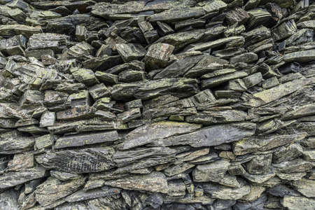 stone wall background from weathered slate stonesの写真素材
