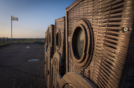 Wicker beach chairs on an evening beach.の写真素材