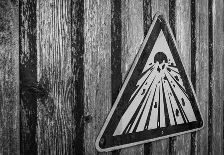 Explosive sign on a weated wooden door.の写真素材