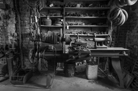 Historic lathe in a abandoned workshop.