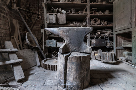 Historic anvil in a abandoned workshop.の写真素材