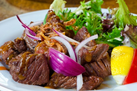 wagyu beefsteak with lettuce, onion on white dish Japanese styleの写真素材