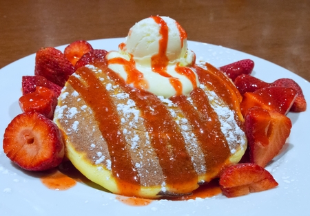 Strawberry pancakes with fresh strawberry, syrup and ice-creamの写真素材