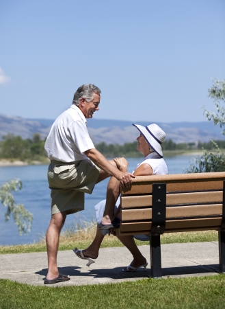 Seniors couple in rural outdoor setting looking at each other, conversing.の写真素材