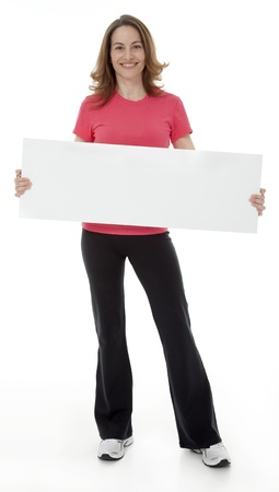 Attractive adult woman standing, holding blank sign, isolated on white.の写真素材