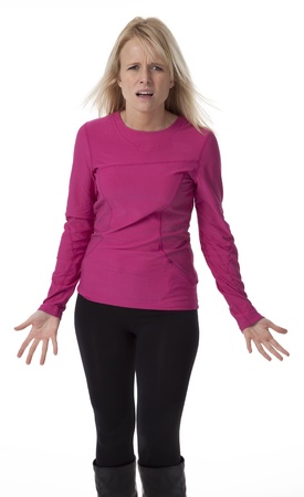 Attractive mid-thirties blond woman standing, with confused facial expression, on white background.の写真素材