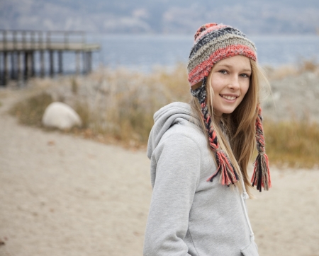 Teenage girl standing in beach setting, looking at camera.の写真素材