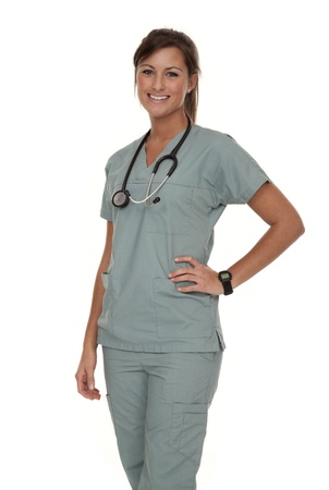 Three quarter view of pretty young nurse wearing green scrubs on white backgroundの写真素材