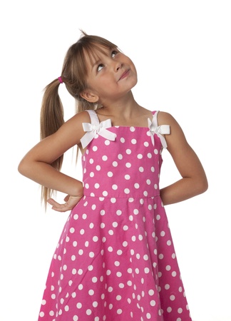 Studio photo of adorable little girl looking upward, isolated on white の写真素材