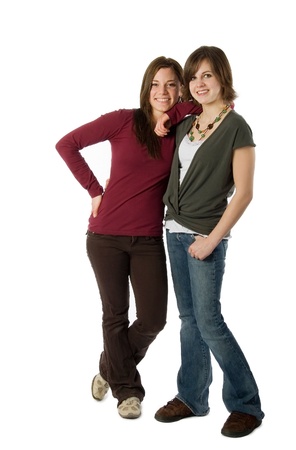 Two teenage girls standing isolated on whiteの写真素材