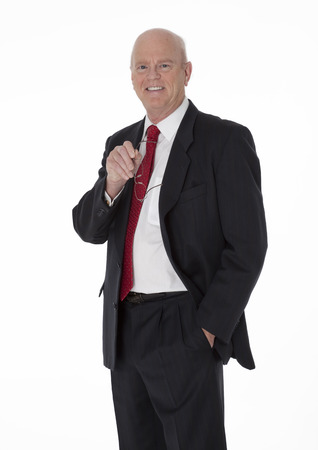 Balding cheerful mature businessman dressed in black business suit standing on white backgroundの写真素材
