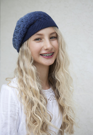 Photo of beautiful young blond girl with bracesの写真素材
