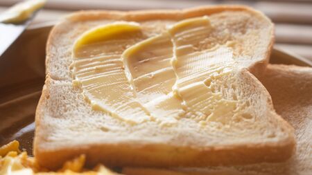 butter spread on sliced bread in close up top viewの写真素材