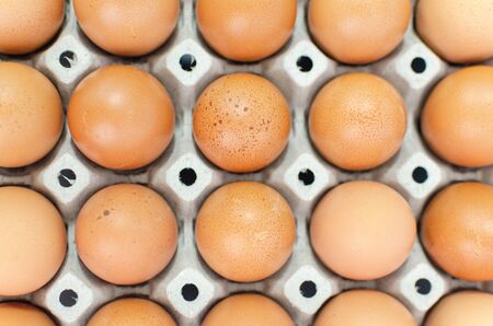 A lot of eggs put on tray on white background and one of these was brokeの写真素材